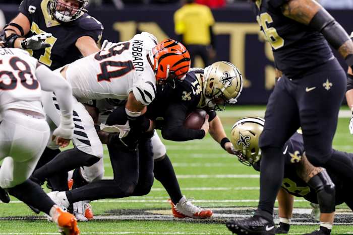 Oct 16, 2022; New Orleans, Louisiana, USA; New Orleans Saints quarterback Andy Dalton (14) is sacked by Cincinnati Bengals defensive end Sam Hubbard (94) during the second half at Caesars Superdome. Mandatory Credit: Stephen Lew-USA TODAY Sports